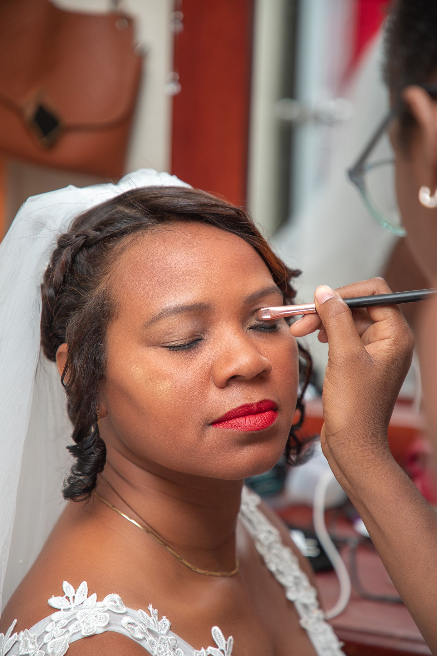 A bride having her makeup finished before the ceremony