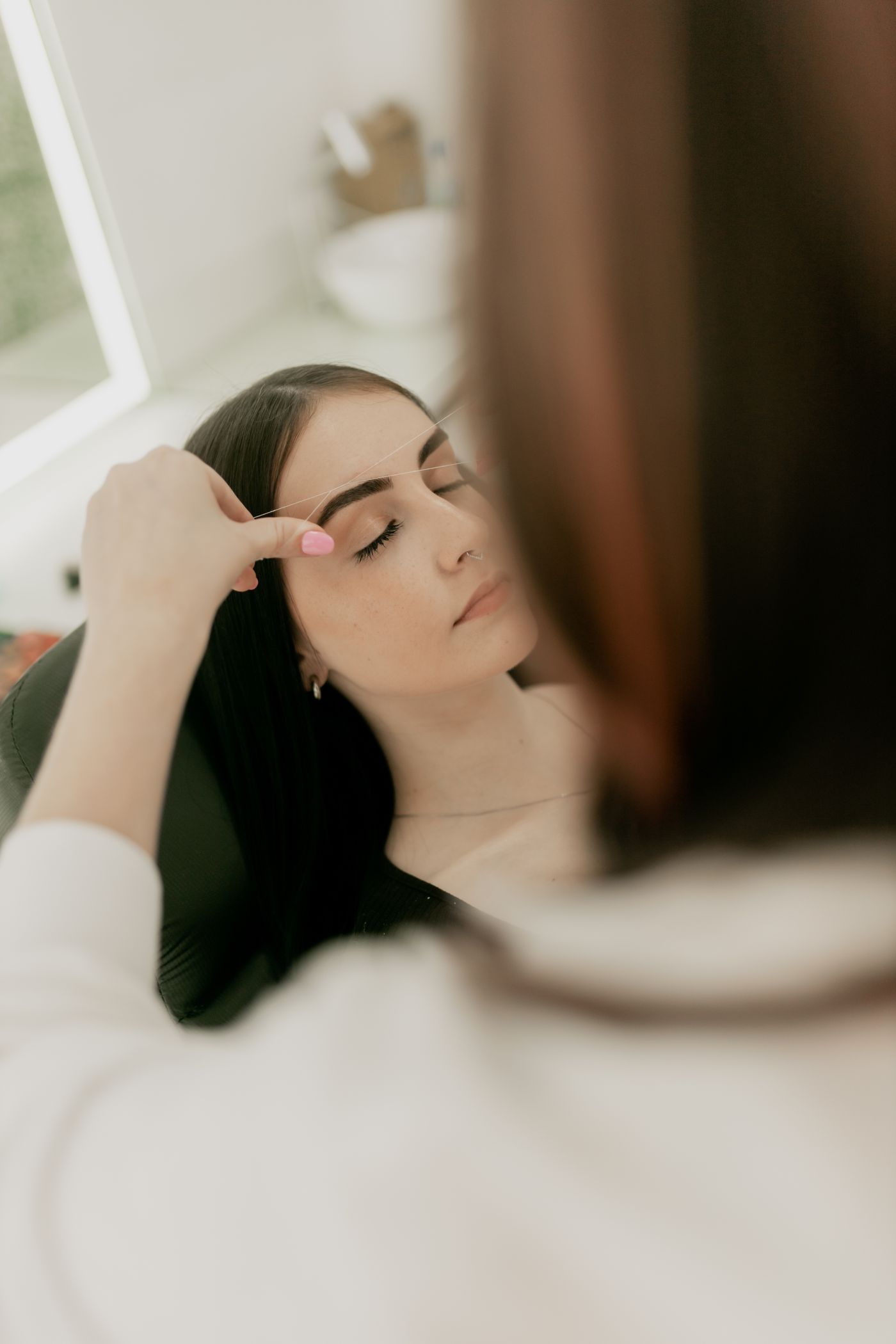 Brows being shaped in a salon