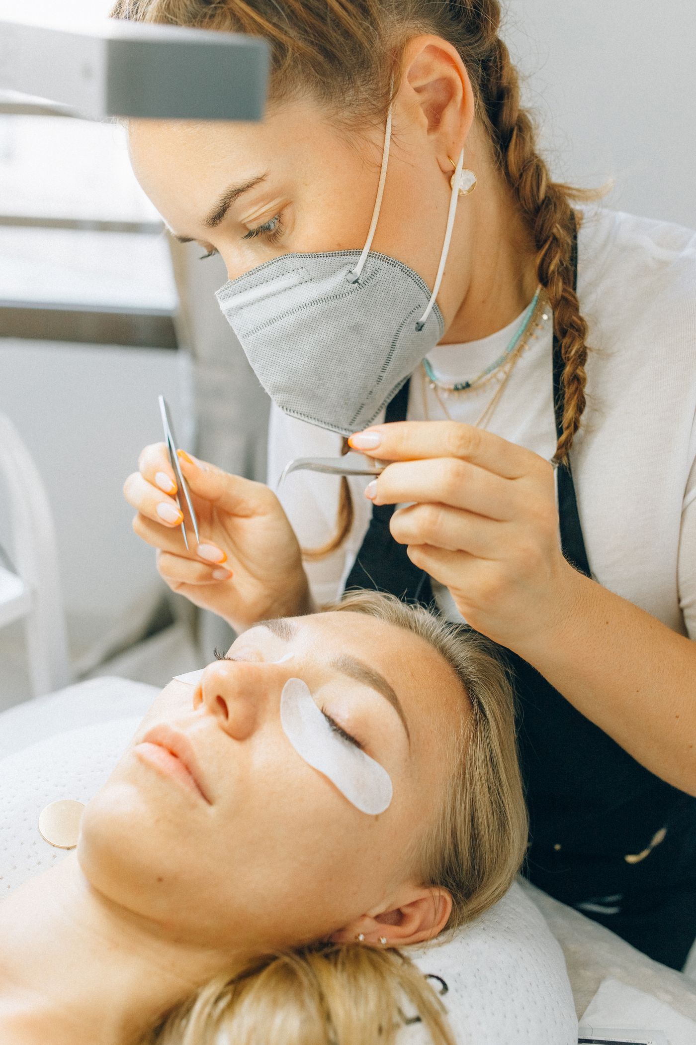 Lash extensions being applied one by one